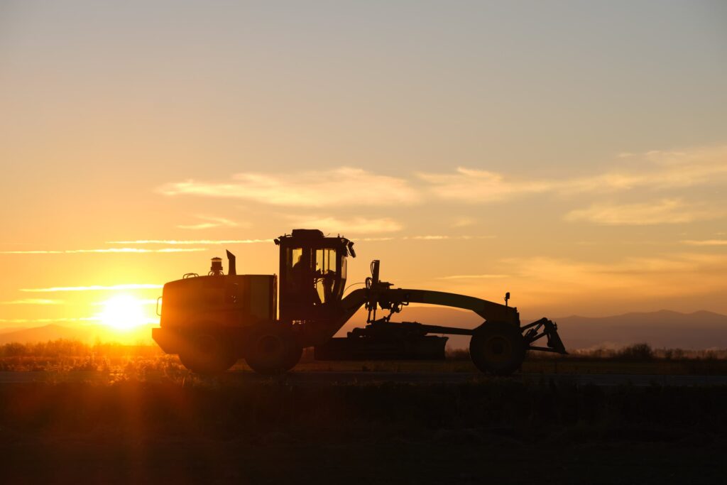 silhouette-of-heavy-duty-tractor-driving-on-road-a-2024-12-06-18-54-49-utc